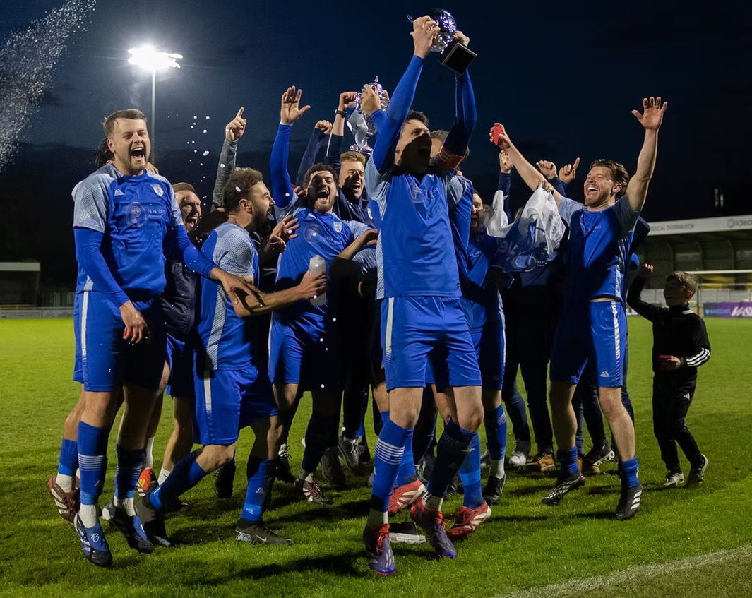 Worcester Park players celebrating under the floodlights
