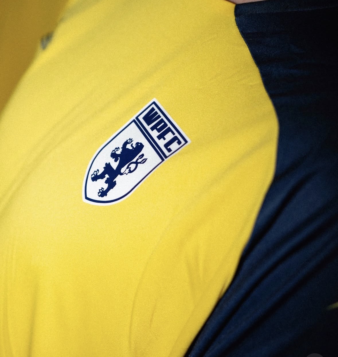 The WPFC lion crest on the yellow reserves shirt